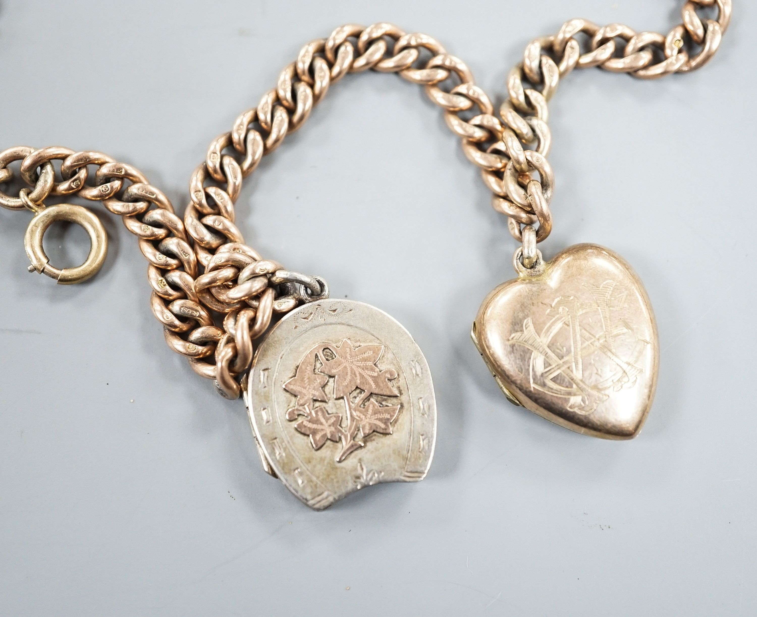 An Edwardian 9ct gold curb link chain, 44cm, hung with a yellow metal locket (gross 36 grams) and a silver locket.